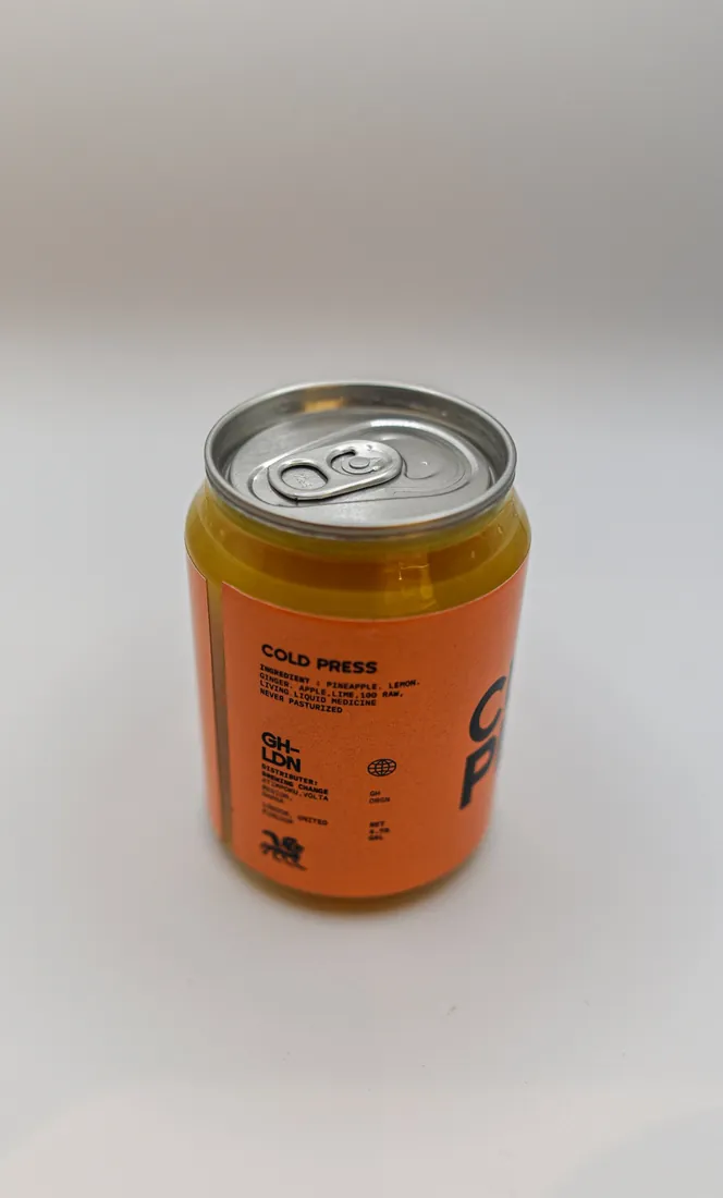 The back label of an orange Brewing Change juice can, headed Cold Press
